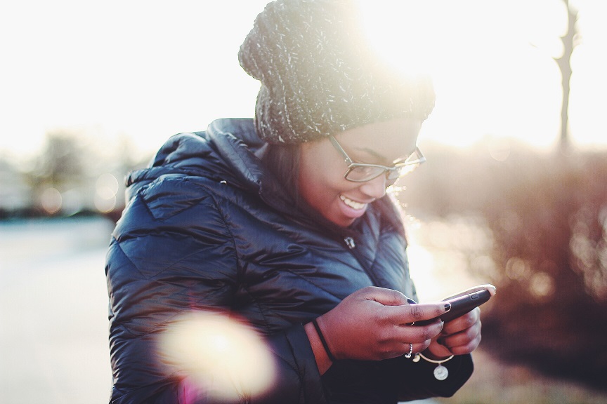 Cell - Woman Smiling at Phone - Medium.jpg